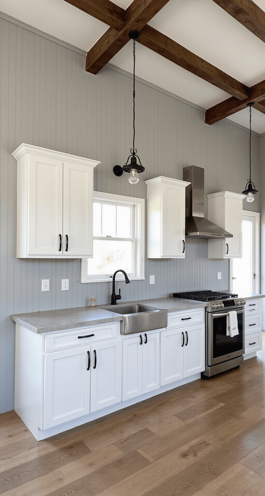 Modern farmhouse kitchen featuring white inset cabinets, a dove gray vertical shiplap backsplash, rustic wooden beams, and vintage-style pendant lights, with morning light accentuating textures and vertical lines.